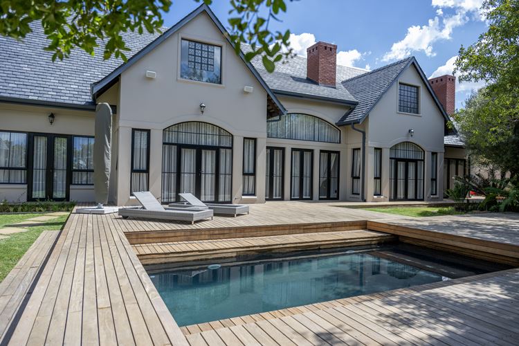 Automated Sliding Deck Pool Covers over a pool with scenic background