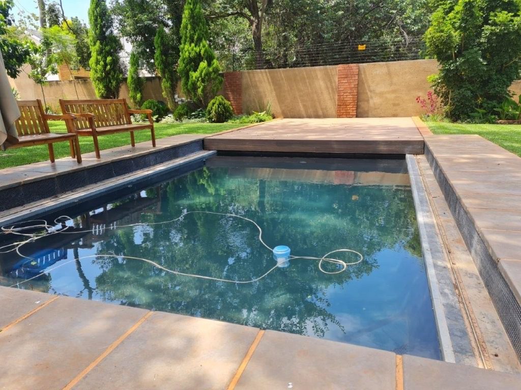 Geani Gold custom-designed pool with automated sliding deck cover in Pretoria, combining luxury aesthetics with innovative safety and space-saving features.