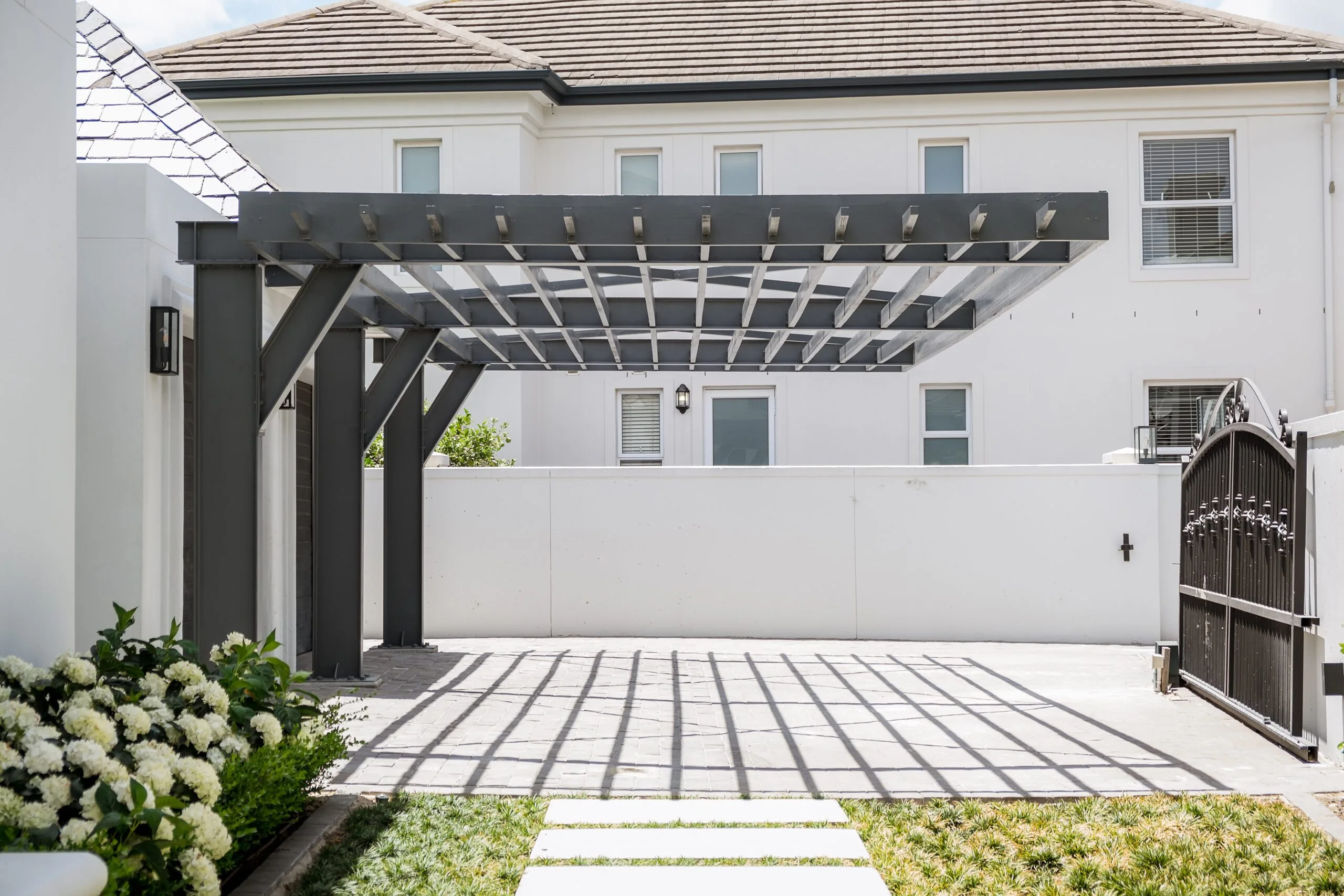 Modern pergola installation with composite decking by Geani Gold in South Africa.